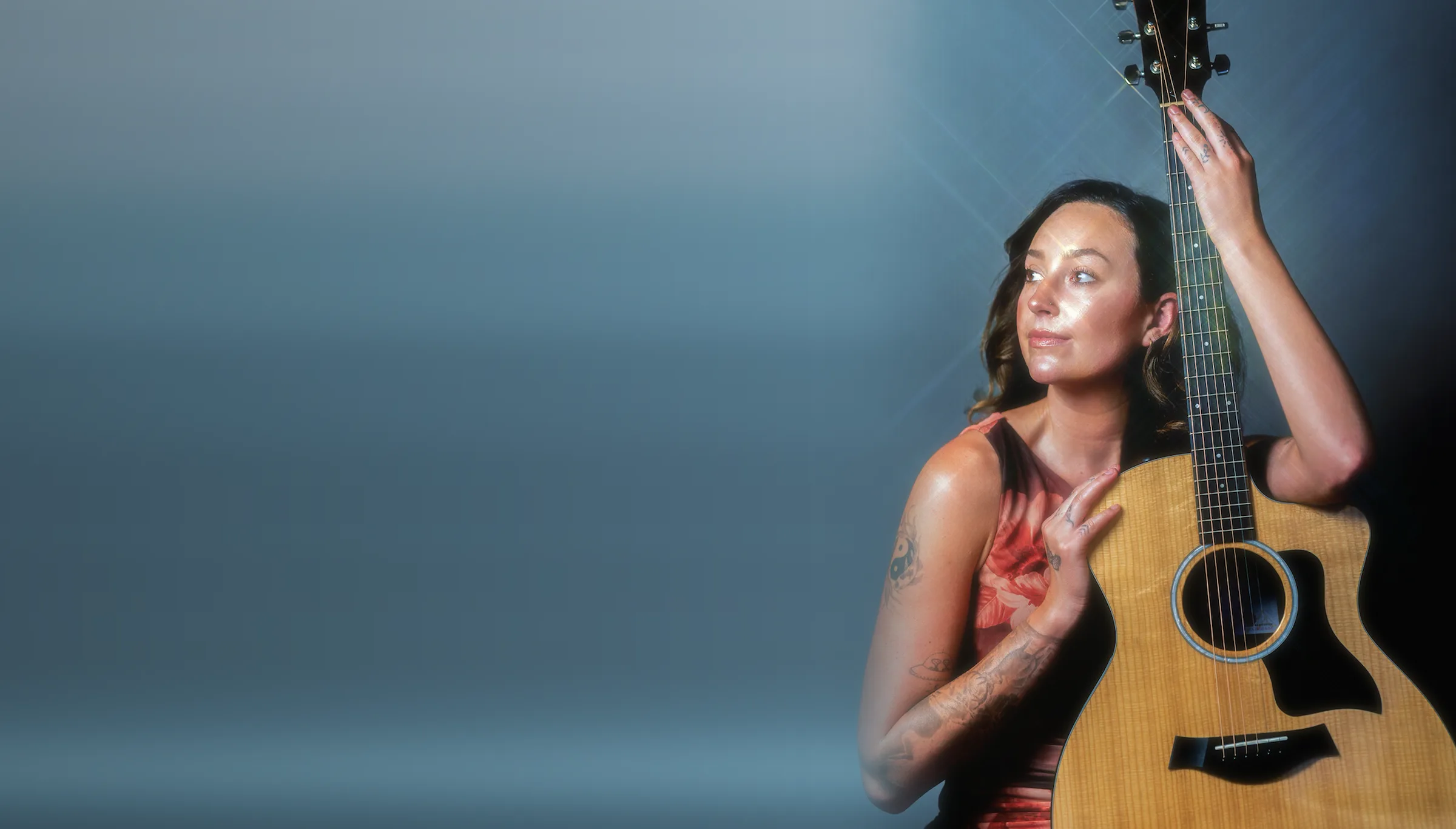 Bella Popa, Temecula singer, holding her Taylor acoustic guitar in the studio