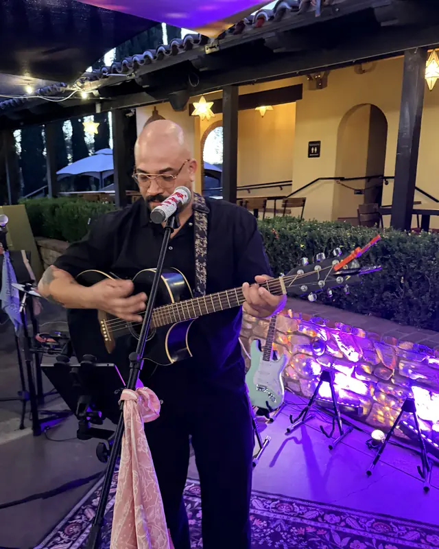 Guitarist singing on the Miramonte Winery open mic stage